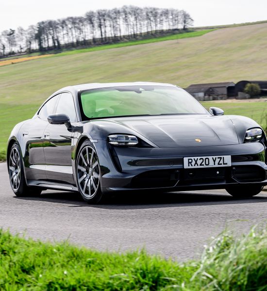 Grey Porsche Taycan turbo driving front
