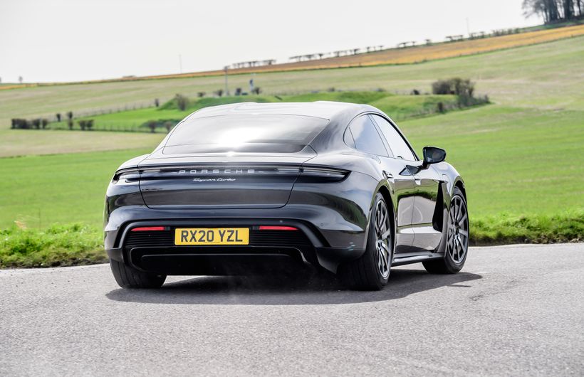 Grey Porsche Taycan turbo parked rear