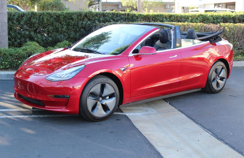 Red Tesla Model 3 convertible front roof down