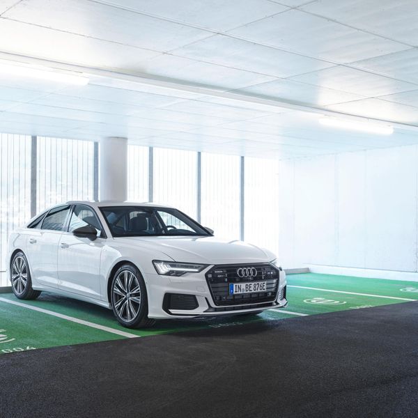 White Audi A6 parked in charging bay front and right side
