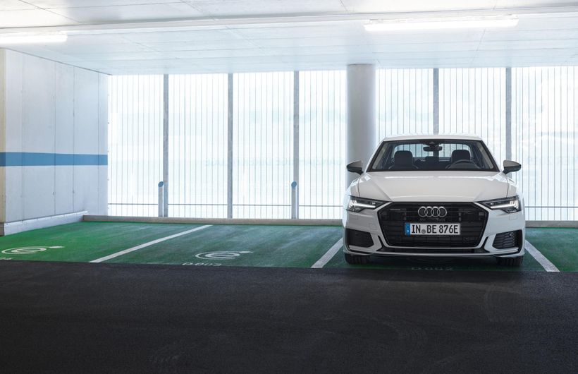 White Audi A6 parked in charging bay front