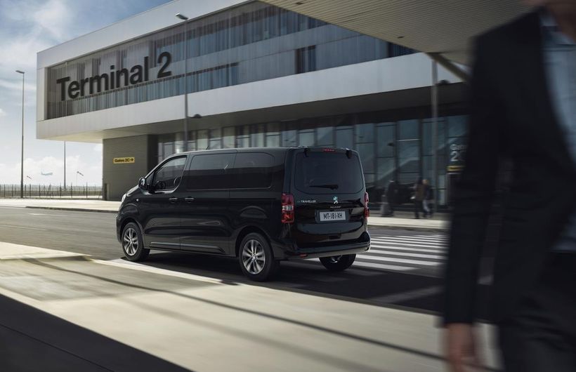 Black Peugeot Travel van rear and side at airport