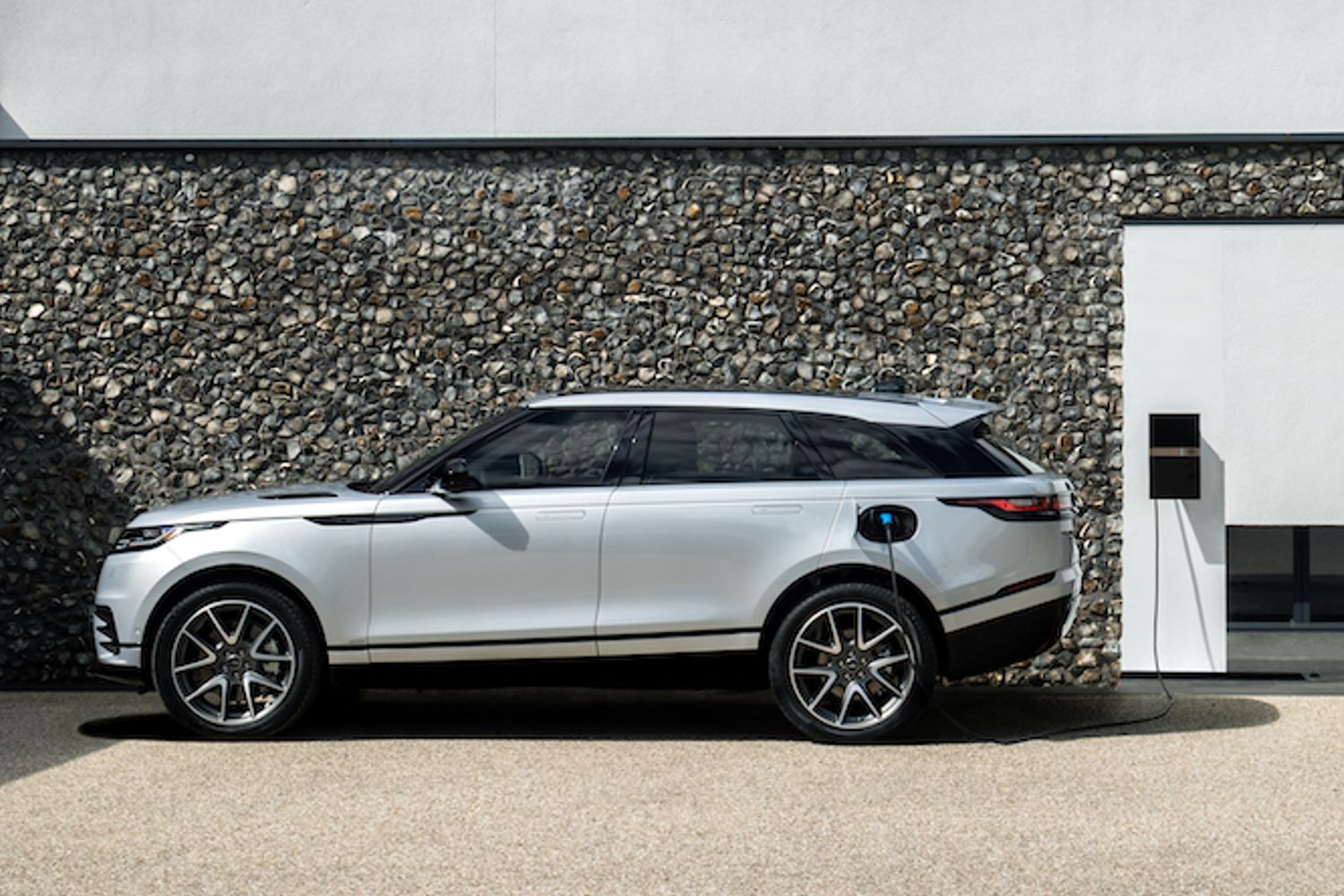 Range Rover Velar P400e exterior side connected to charger
