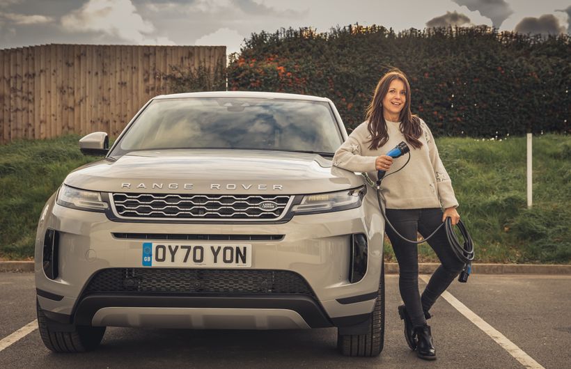 Ginny Buckley with cable next to Range Rover electric car