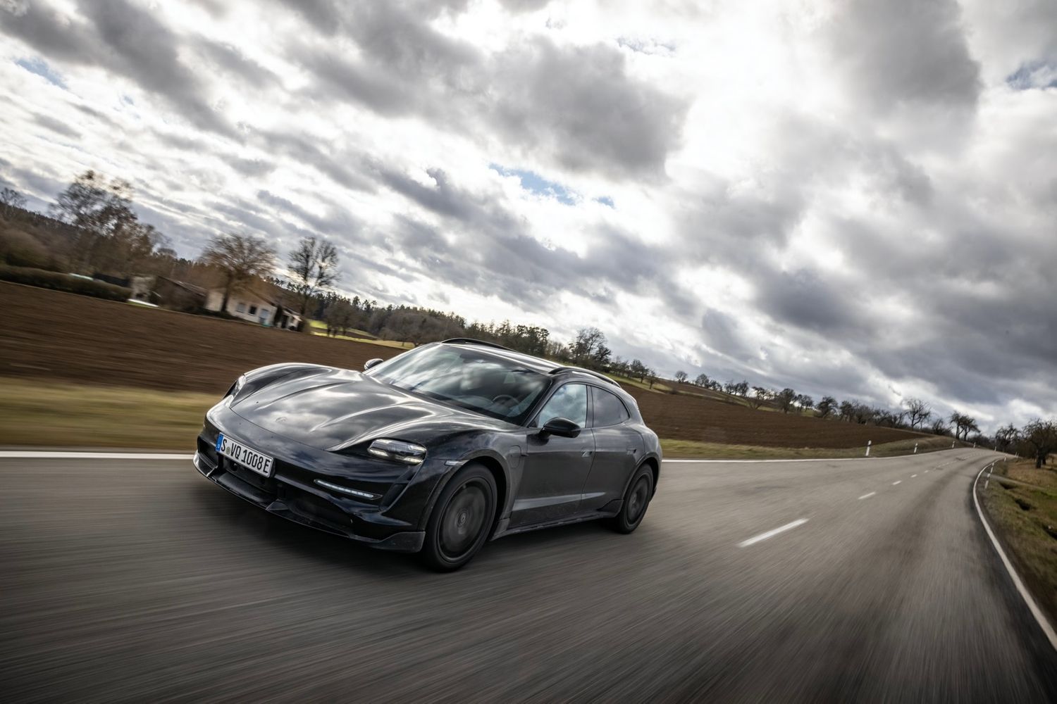 Porsche Taycan Cross Turismo driving in countryside