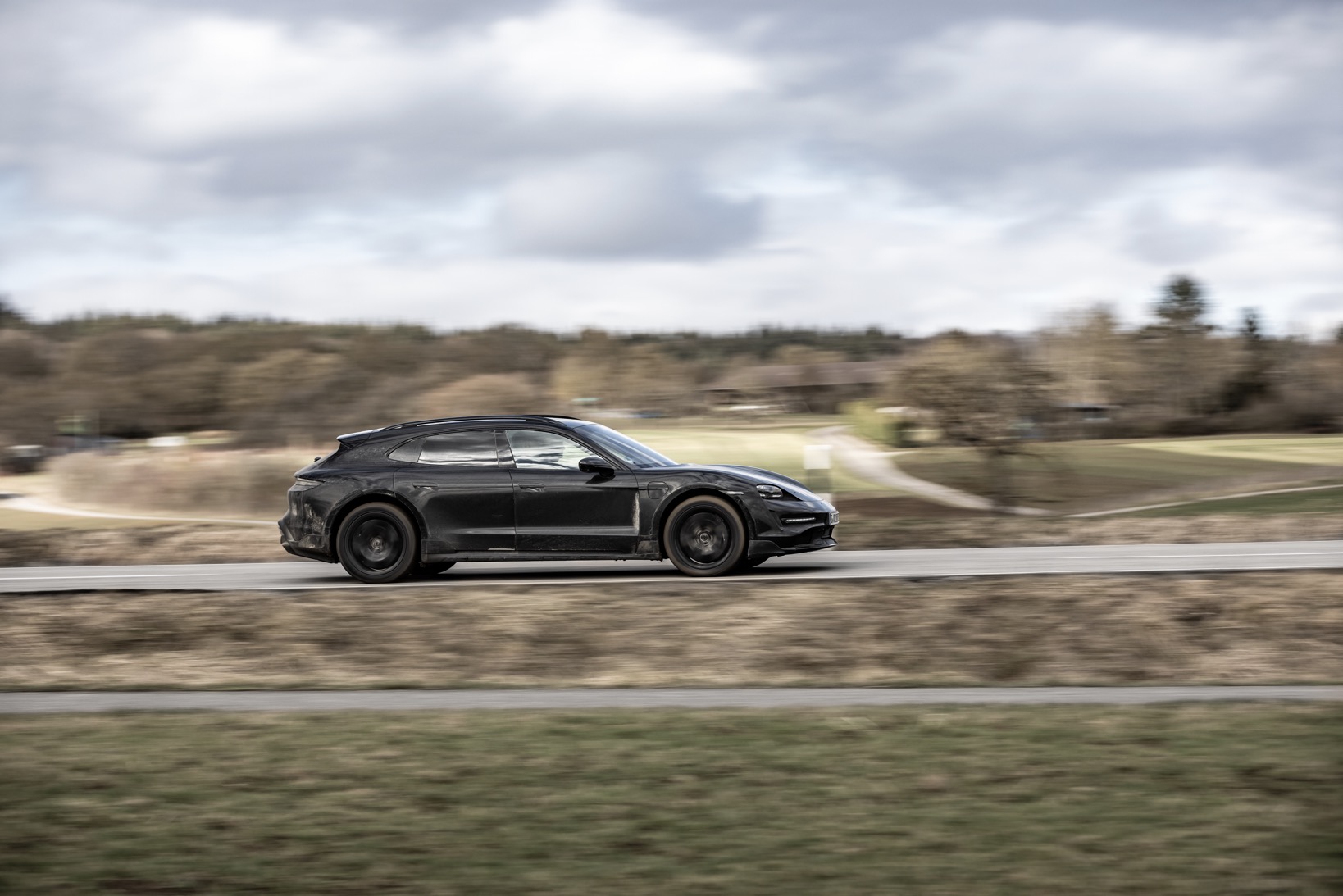 Porsche Taycan Cross Turismo driving in countryside