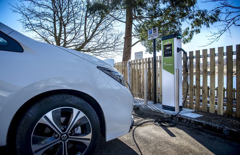 White Nissan Leaf at public charger