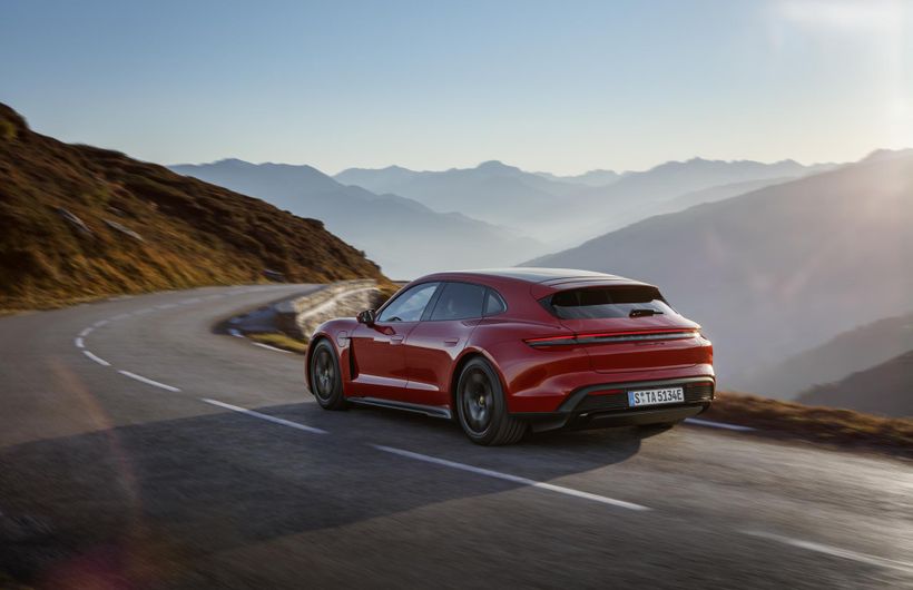 Porsche Taycan Sport Turismo, red, rear action shot on mountain road