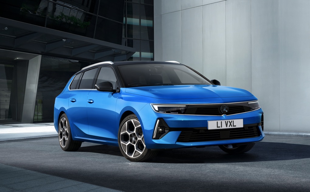 Blue 2022 Vauxhall Astra Sports Tourer front 3/4 shot, UK numberplate, office building in background
