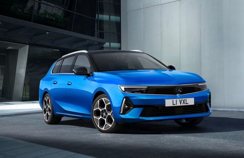 Blue 2022 Vauxhall Astra Sports Tourer front 3/4 shot, UK numberplate, office building in background
