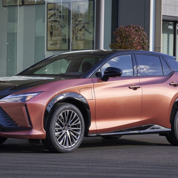 Lexus RZ 450e static, copper, in front of office building