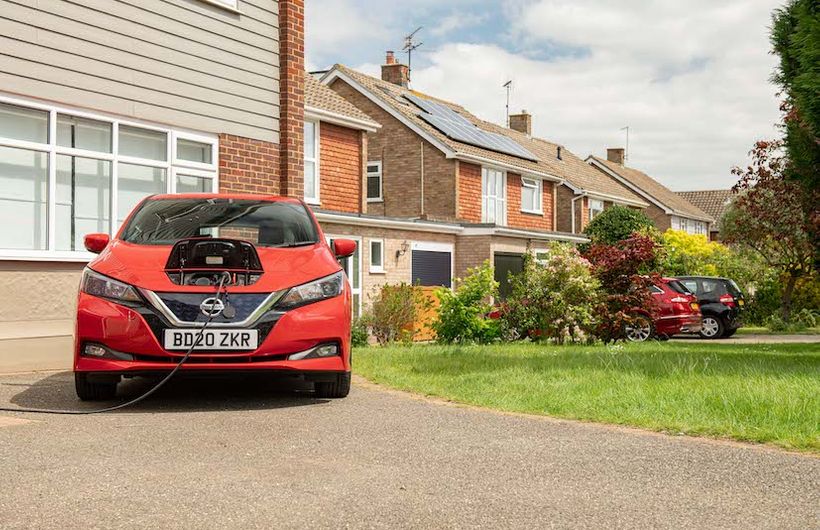 Nissan Leaf, red, 2020, charging on suburban driveway