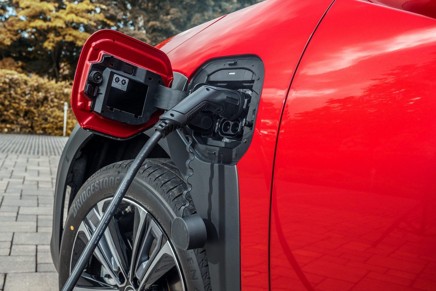Toyota bZ4x charging close up detail red car