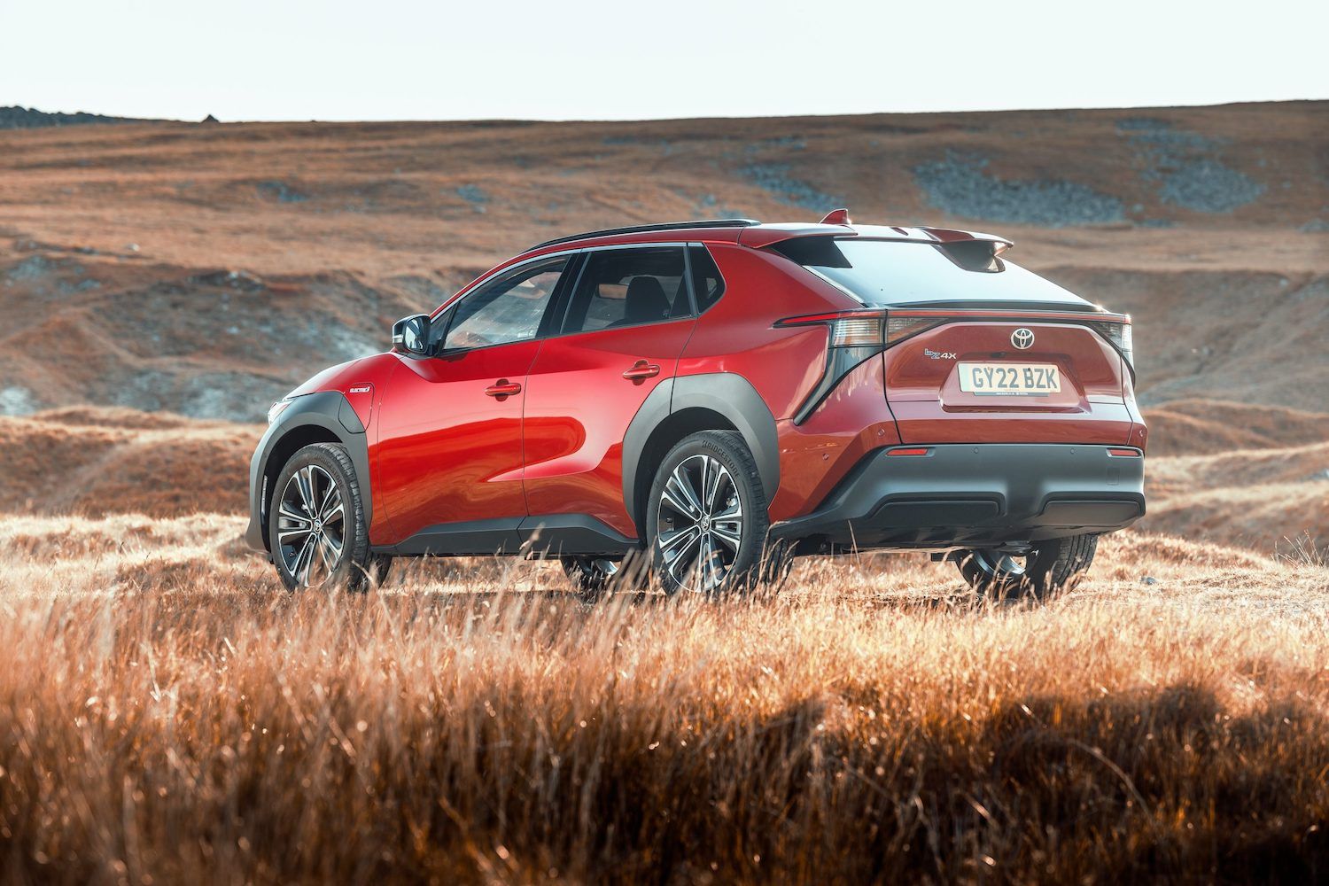 Toyota bZ4x static shot, rear, red car, RHD UK registration