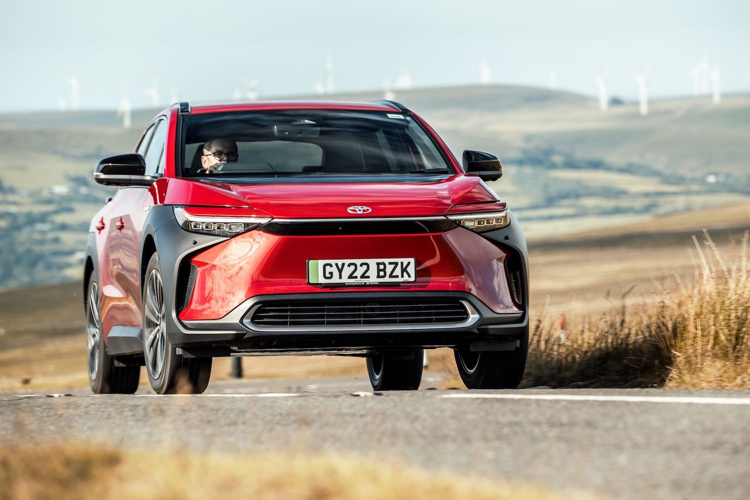 Toyota bZ4x action, front, red car, RHD UK registration