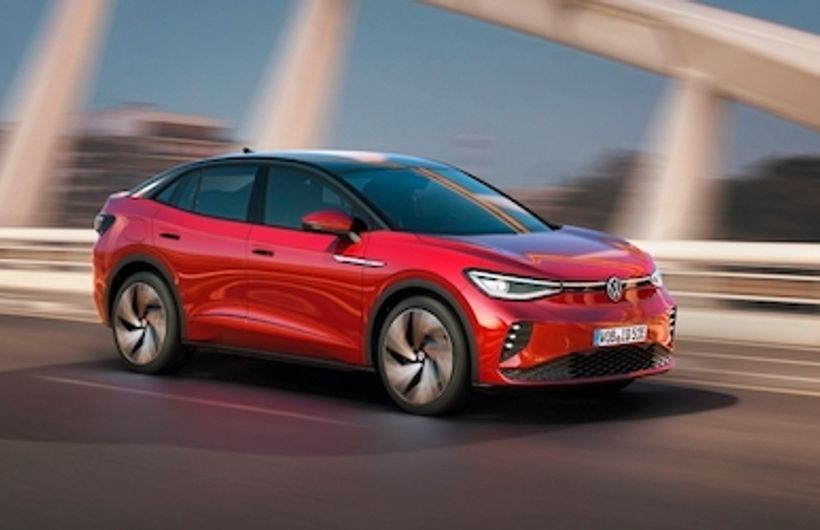 Volkswagen ID.5 front action shot on bridge with German registration, red car
