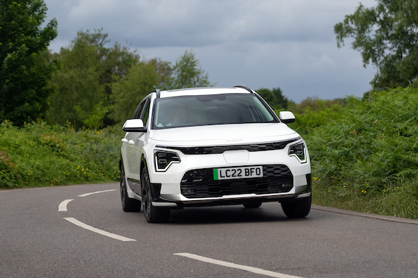 Kia Niro ev, white, action shot, front three angles