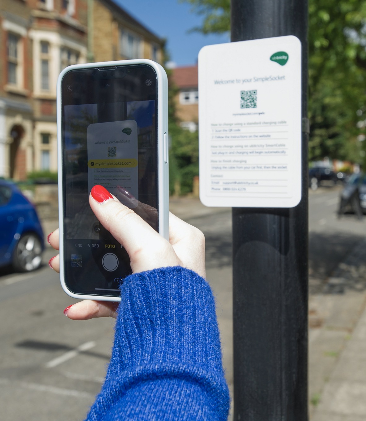 Ubitricity charge point app being used by person with smartphone in UK