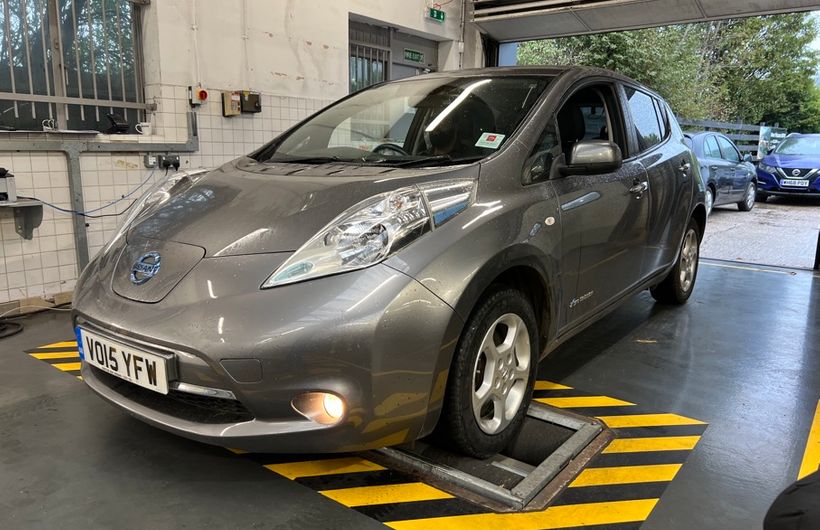 Grey 2015 Nissan Leaf on MoT brake test rollers in workshop