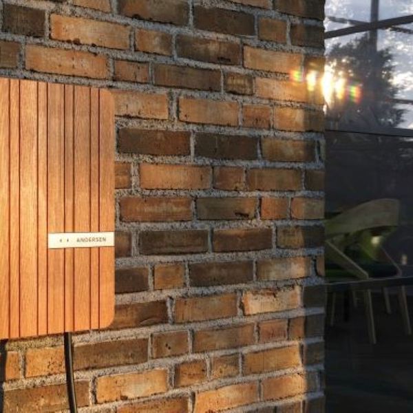 Wood finish Anderson A2 wall charger attached to modern house