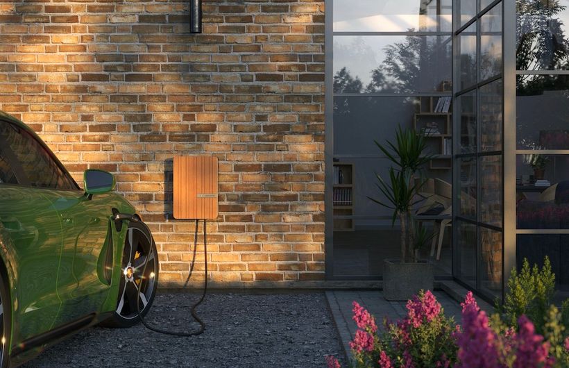 Anderson A2 wall charger attached to modern house and connected to a Porsche Taycan