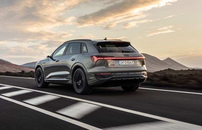 Audi Q8 e-tron rear tracking action shot, green car,  left hand drive car