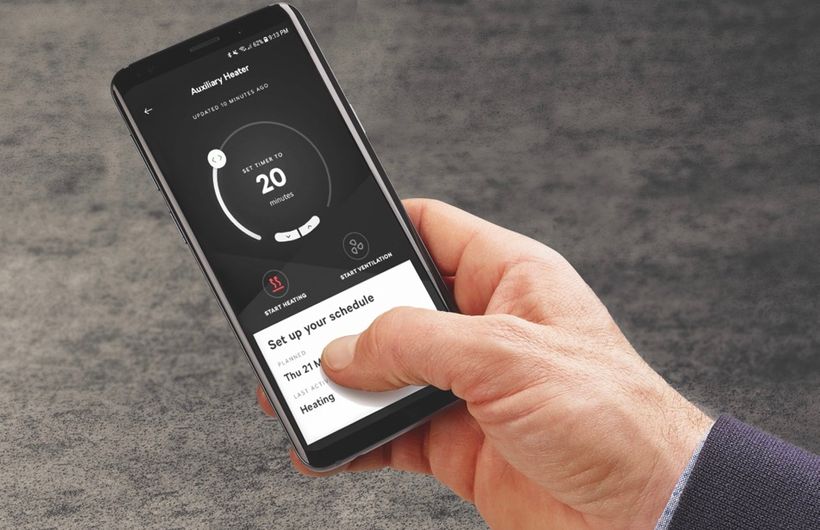 Smartphone showing app to preheat an electric car